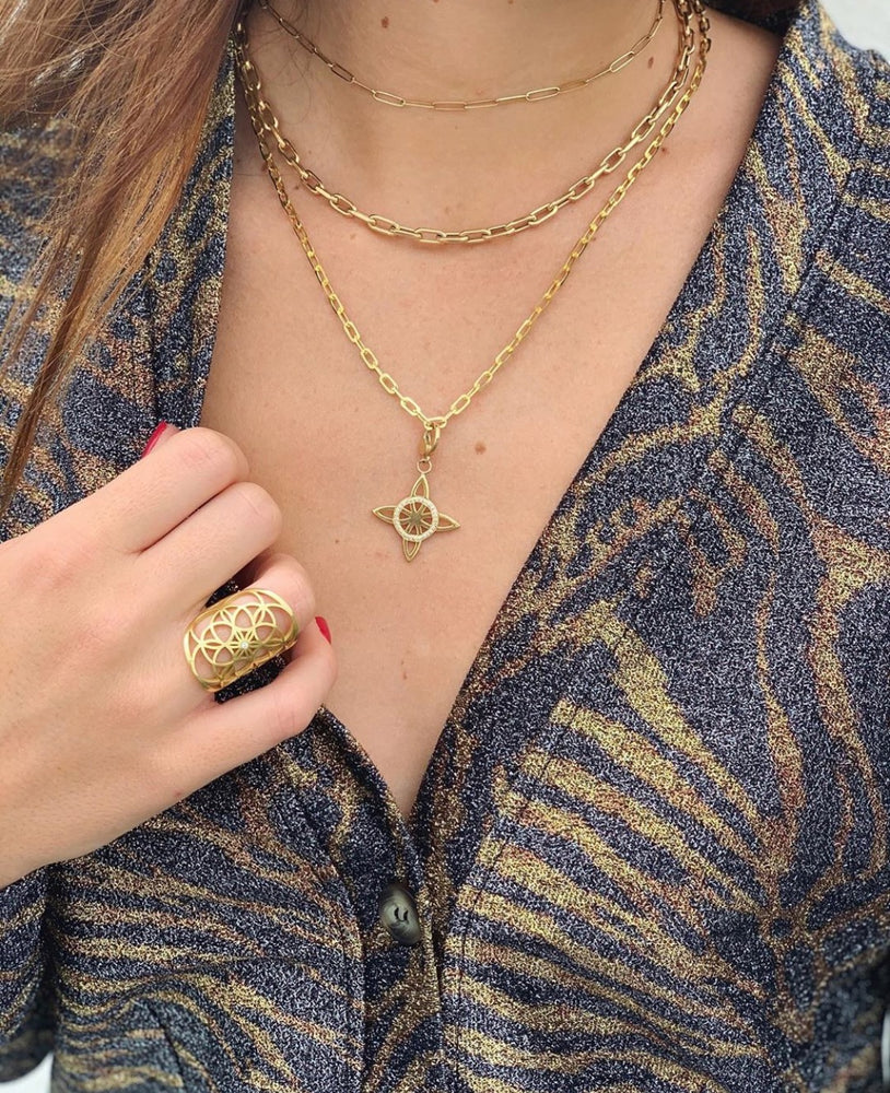 
                  
                    The charm is shown here on a chunky link necklace.
                  
                